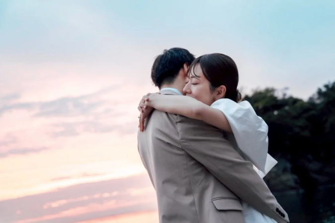 夕焼けに抱き合うカップル