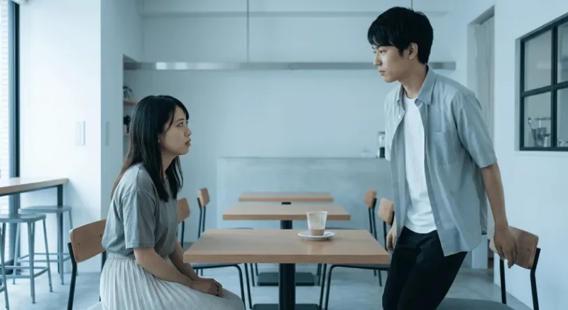 カフェで真剣な表情で会話する若い男女